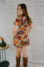 tan tapestry material puff sleeve romper with belt floral